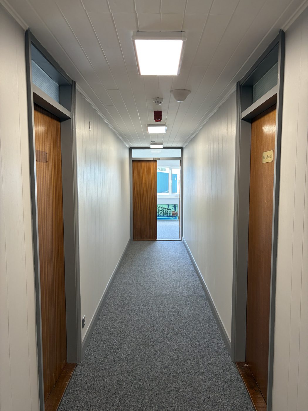 Office corridor decorated by CWB Decorators in white and grey