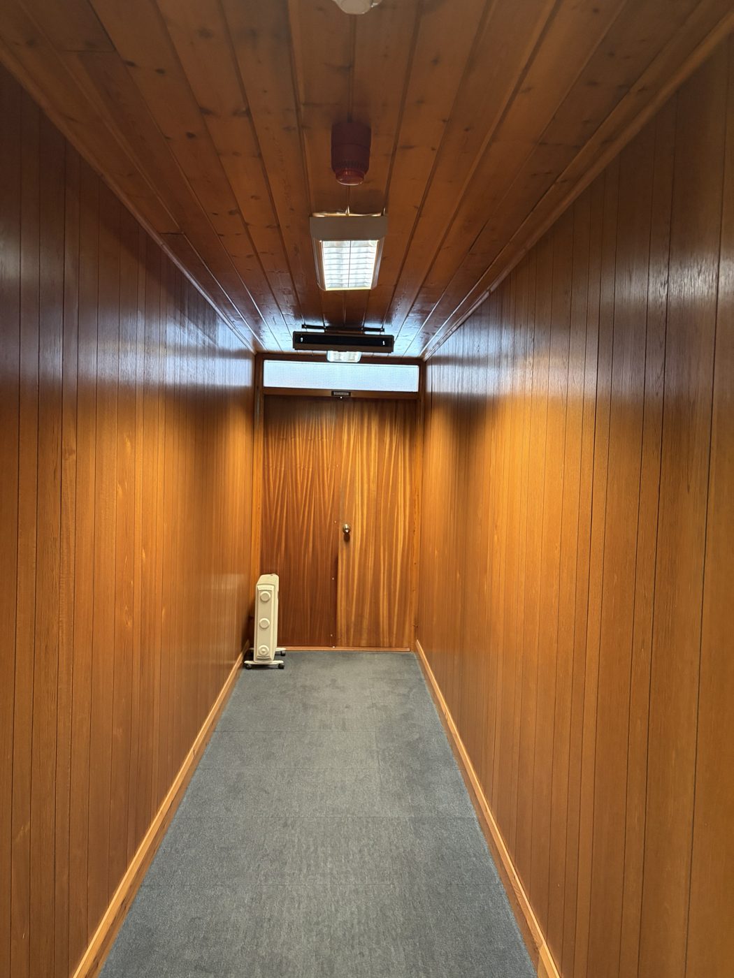 Boardroom corridor before decoration, fully lined in timber panelling